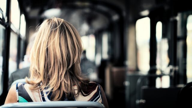 Person i en buss som sitter med ryggen mot kameran